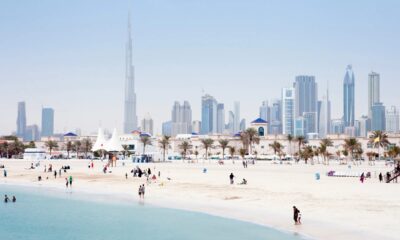 UAE employment law guide showing Dubai Courts building with legal documents and employment contract on desk