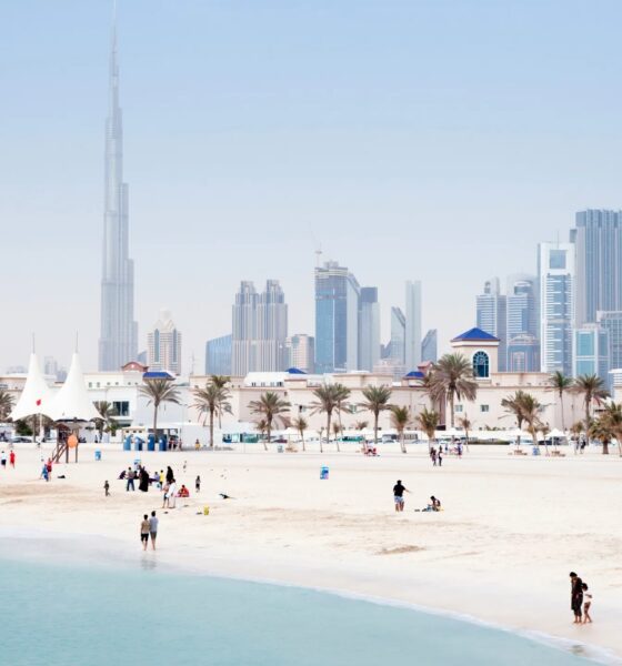 UAE employment law guide showing Dubai Courts building with legal documents and employment contract on desk