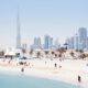 UAE employment law guide showing Dubai Courts building with legal documents and employment contract on desk