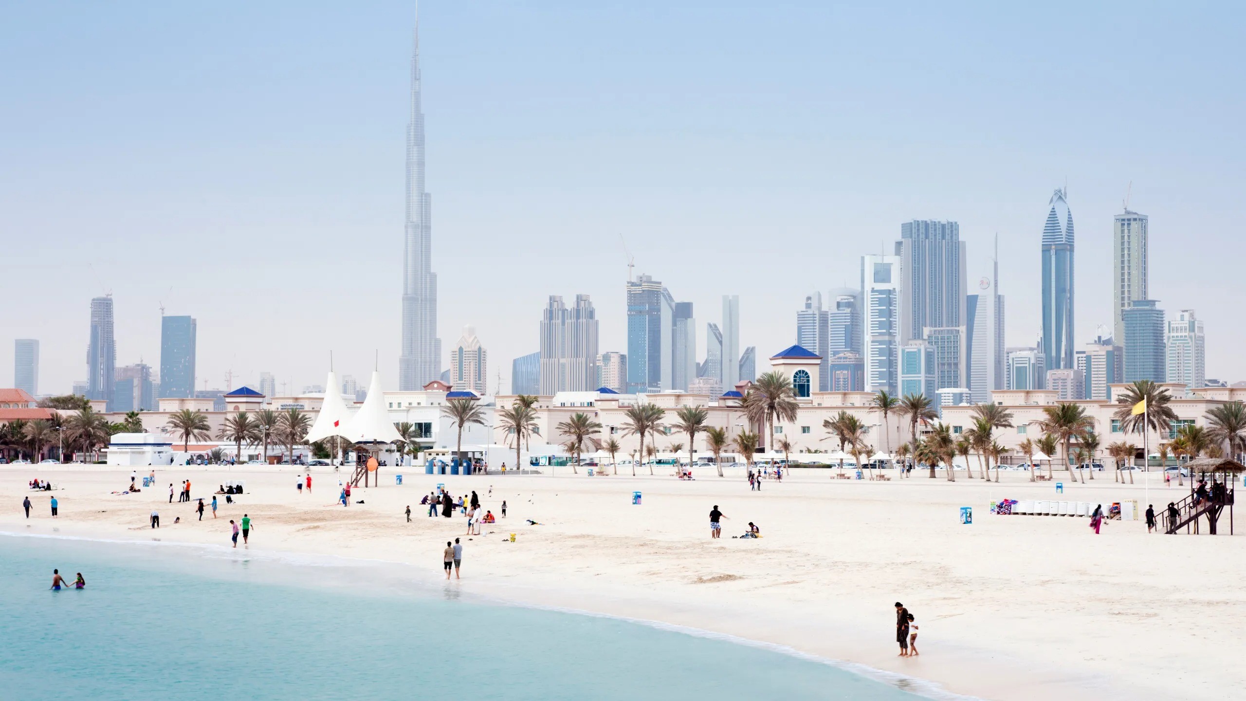 UAE employment law guide showing Dubai Courts building with legal documents and employment contract on desk