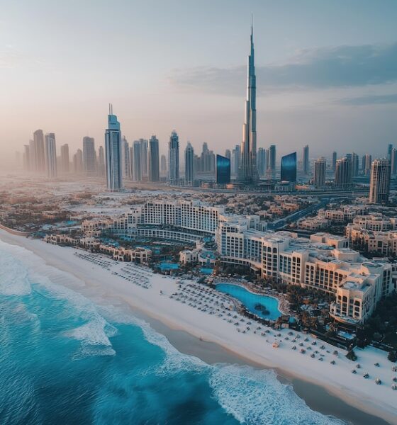 “Dubai Metro train passing Downtown Dubai skyline at sunset”